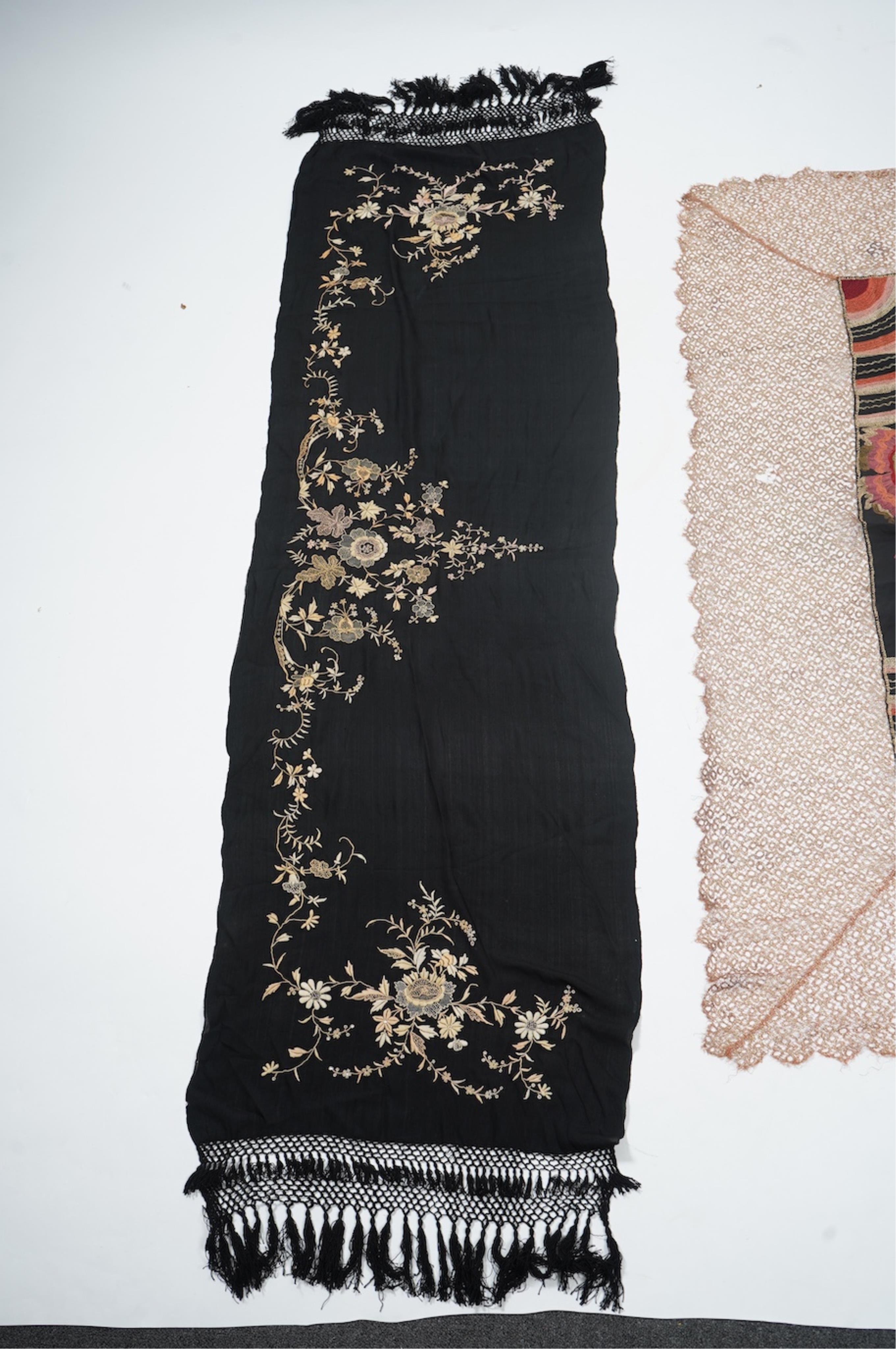 An Art Deco black silk floral embroidered shawl, using tones of red and orange with gold highlights, bordered with bronze metallic lace, together with a black crepe and yellow silk embroidered stole. Art Deco stole, 142c